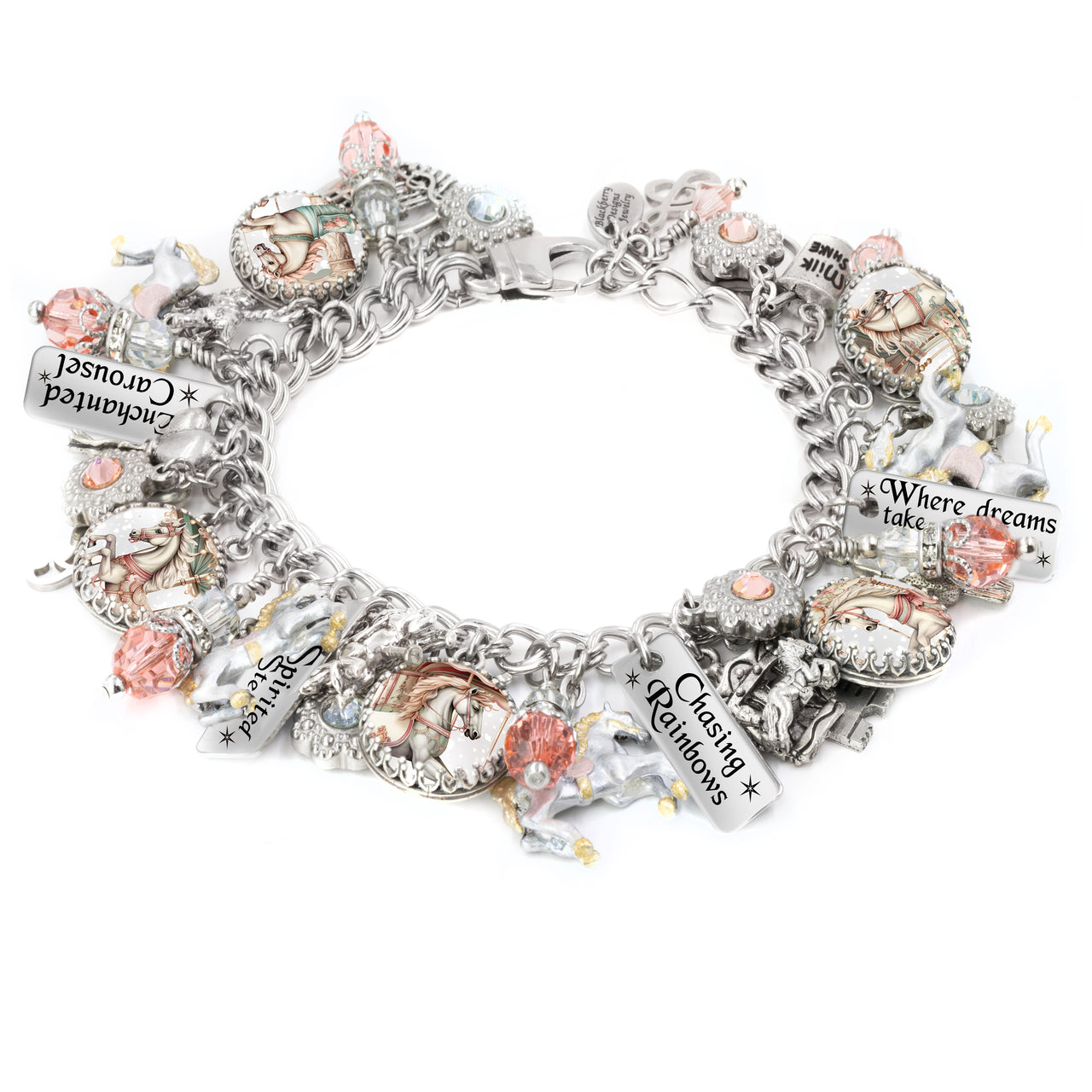 Silver charm bracelet featuring soft pastel carousel horse images, pink and peach Austrian crystals, engraved tags like “Chasing Rainbows” and “Where dreams take flight,” with hand-painted unicorn and horse charms, styled on a white background.
