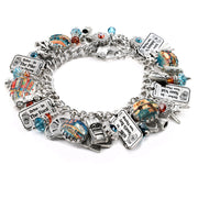 Drive-In Movie charm bracelet with vintage movie theater charms, engraved ticket stubs, classic car charms, and red, aqua, and turquoise Austrian crystals on stainless steel chain.