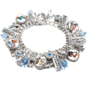 Handcrafted silver charm bracelet celebrating thrifting and treasure hunting, featuring artwork under glass cabochons of vintage finds, retro fashion, garage sales, and flea markets. Includes engraved tags with phrases like ‘Thrift Store Queen,’ ‘Garage Sale Diva,’ and ‘I Brake for Yard Sales.’ Accented with light blue Austrian crystals and detailed charms like old cash registers, cameras, and signs. Displayed on a white background.