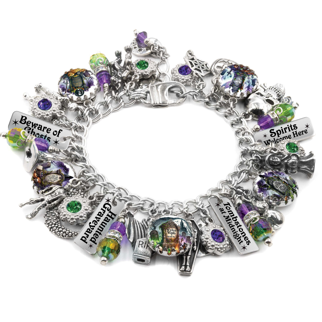 Handcrafted silver charm bracelet with a haunted graveyard theme, featuring spooky artwork under glass cabochons including tombstones, ghosts, haunted houses, and witches. Includes engraved tags with phrases like ‘Beware of Ghosts,’ ‘Zombies at Midnight,’ and ‘Spirits Welcome Here.’ Accented with green, purple, and orange Austrian crystals and Halloween-themed charms like skulls, cauldrons, and gravestones. Displayed on a white background.
