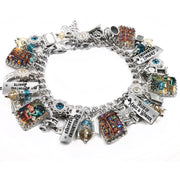Library charm bracelet with silver book charms, engraved sayings like “Enchanted Library” and “Tales of Magic & Wonder,” sparkling crystals, and handcrafted artwork under glass.