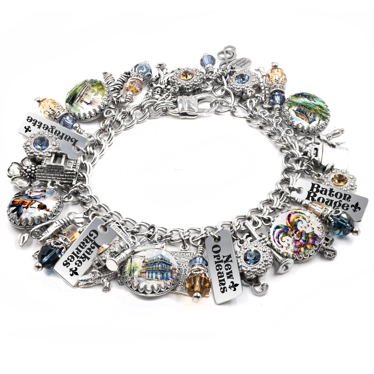 Silver charm bracelet inspired by Louisiana, featuring detailed charms like an alligator, steamboat, fleur-de-lis, magnolia, and Louisiana map, accented with blue and gold crystals and engraved sayings like “Cajun Queen” and “French Quarter.”