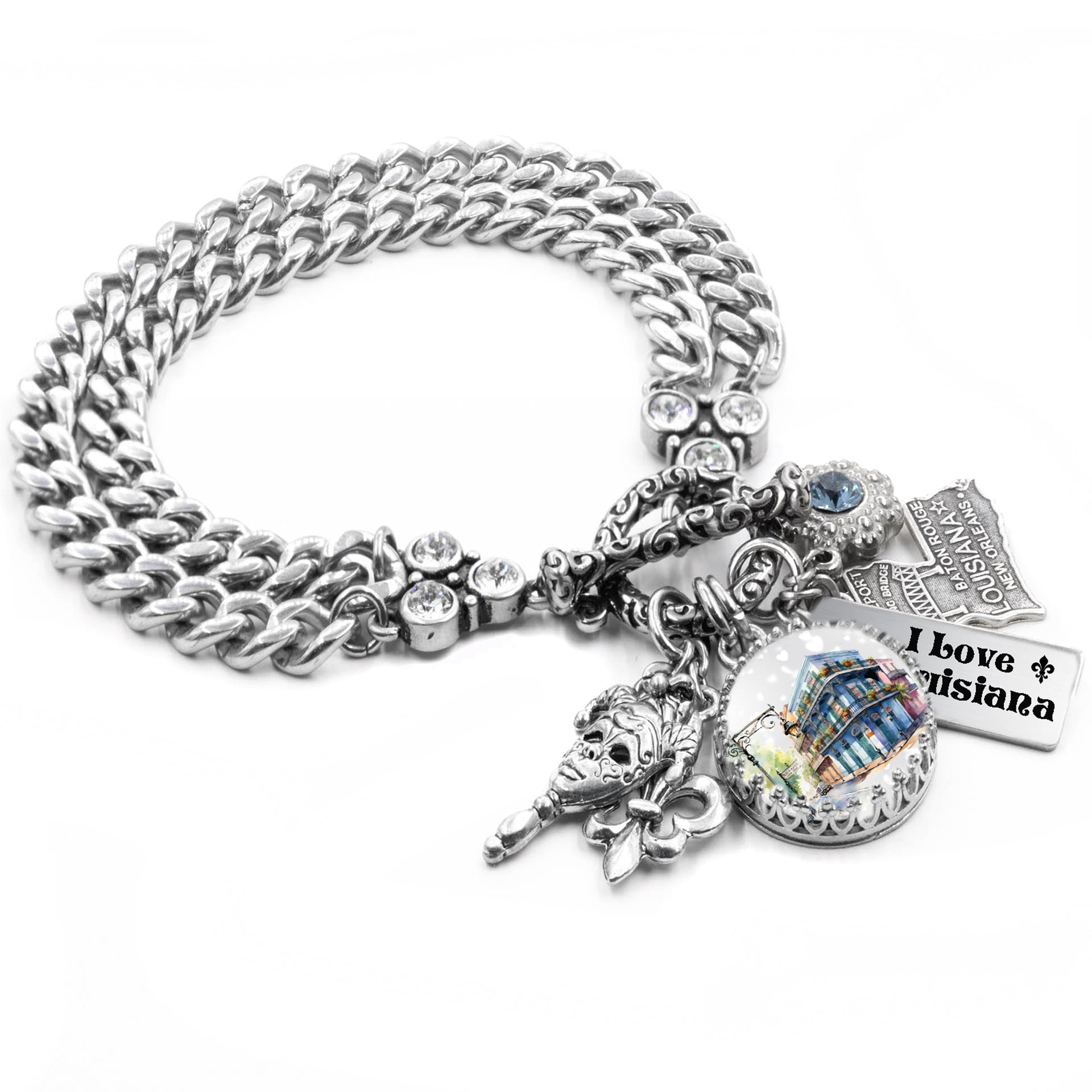 Silver charm bracelet inspired by Louisiana, featuring fleur-de-lis charms, Mardi Gras mask, French Quarter scenes, and state symbols, accented with blue and gold Austrian crystals and engraved tags like āBayou Stateā and āCajun Queen.ā