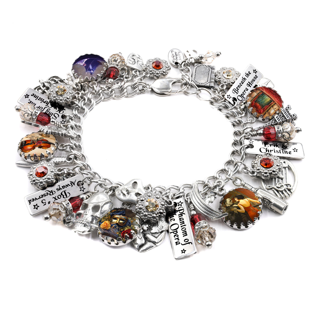 Handcrafted silver charm bracelet inspired by Phantom of the Opera, featuring charms of masks, opera house details, keys, skulls, and artwork of Christine and the Phantom under glass cabochons. Accented with red, clear, and black Austrian crystals and engraved tags like ‘Erik & Christine,’ ‘Box 5 Always Reserved,’ and ‘Beneath the Opera House.’ Displayed on a white background.