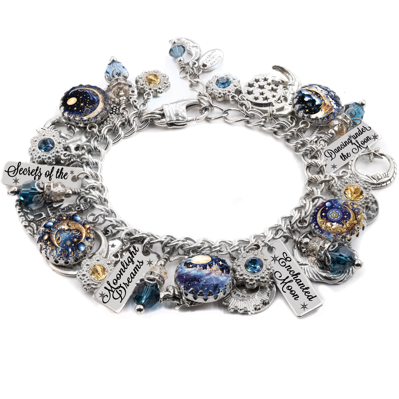 Handcrafted silver charm bracelet inspired by celestial and lunar themes, featuring moon and star charms, deep blue and gold artwork under glass cabochons, and engraved tags with phrases like ‘Enchanted Moon,’ ‘Moonlight Dreams,’ and ‘Dancing Under the Moon.’ Embellished with blue and gold Austrian crystals, crescent moons, stars, and mystical motifs. Displayed on a white background.