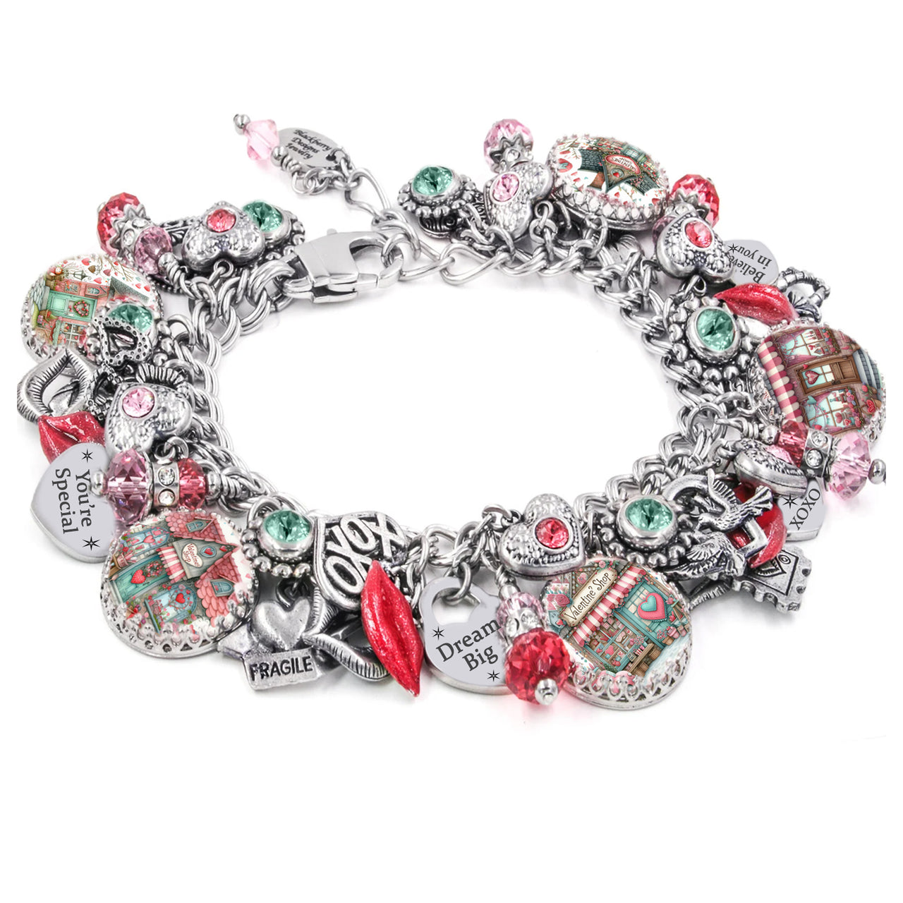 Handcrafted silver charm bracelet featuring romantic and uplifting charms including hearts, lips, love letters, and pink houses with heart details. Includes artwork under glass cabochons and engraved sayings like ‘You’re Special,’ ‘Dream Big,’ and ‘Believe in You.’ Embellished with pink, red, and mint green Austrian crystals. Displayed on a white background.