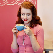 woman wearing breast cancer jewelry