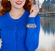 closeup of woman wearing Peter Pan jewelry