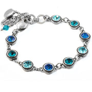a silver bracelet with austrian crystal in shades of dark blue to light blue, in stainless, non tarnish, with charms of seashell and engraving, dance to the song of the sea