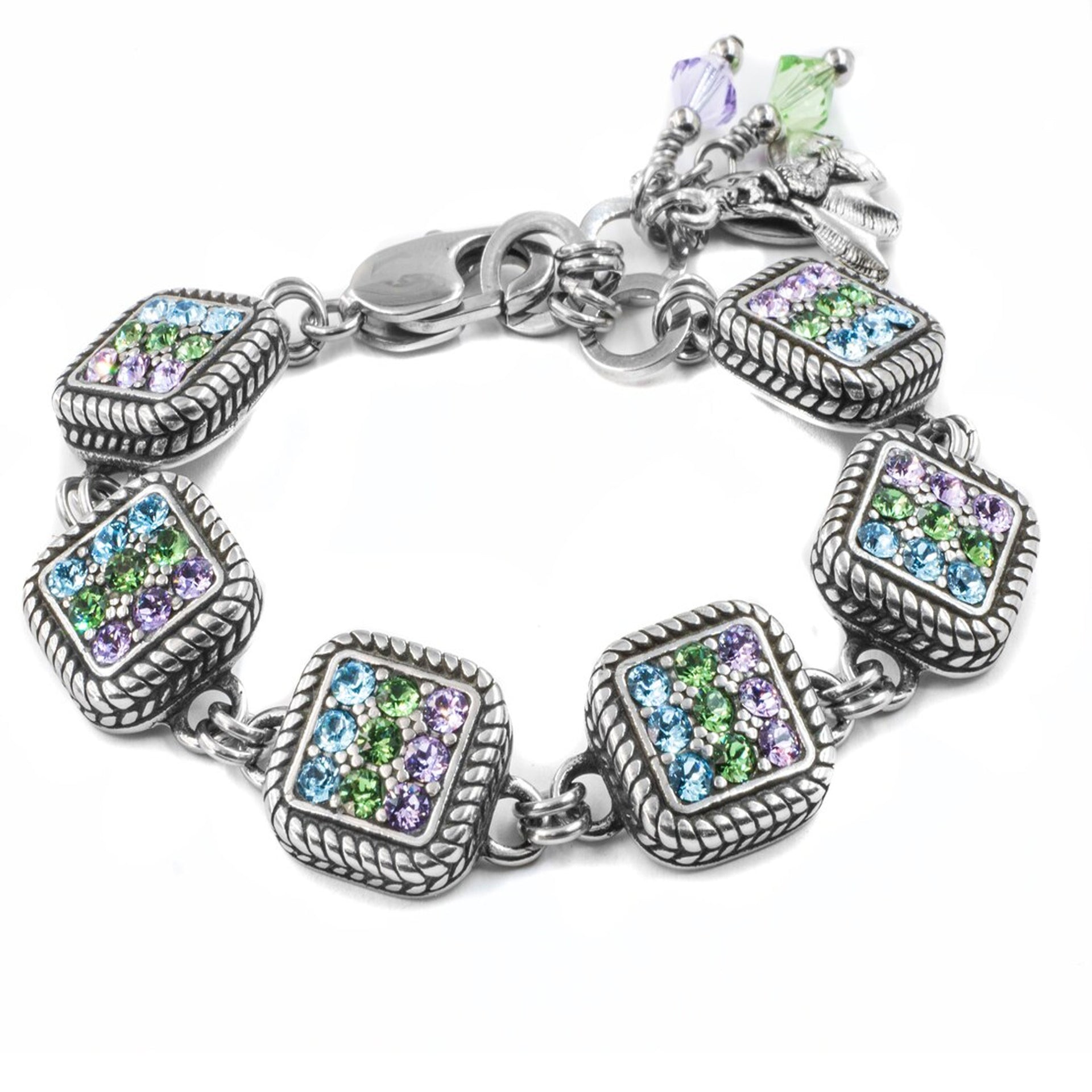 A silver-toned bracelet adorned with colorful gemstones, including blue, green, and purple stones, and a charm at the end.