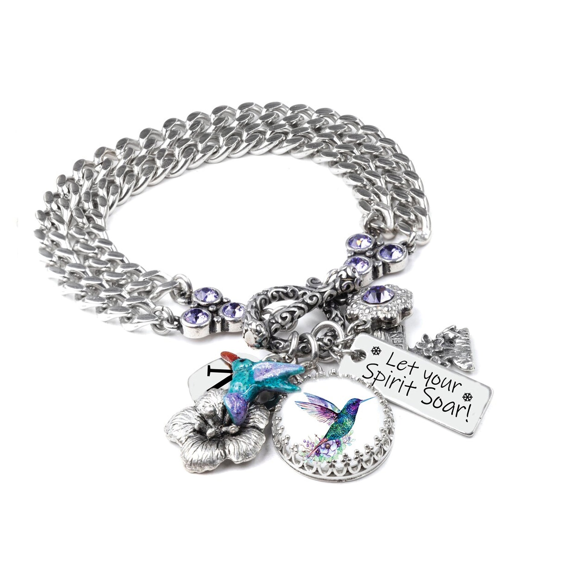 A silver-toned charm bracelet with various charms, including a bird charm, a flower charm, and a small bird charm. The bracelet also has a charm that says "Let your Spirit Soar!" and a small charm with a bird design.