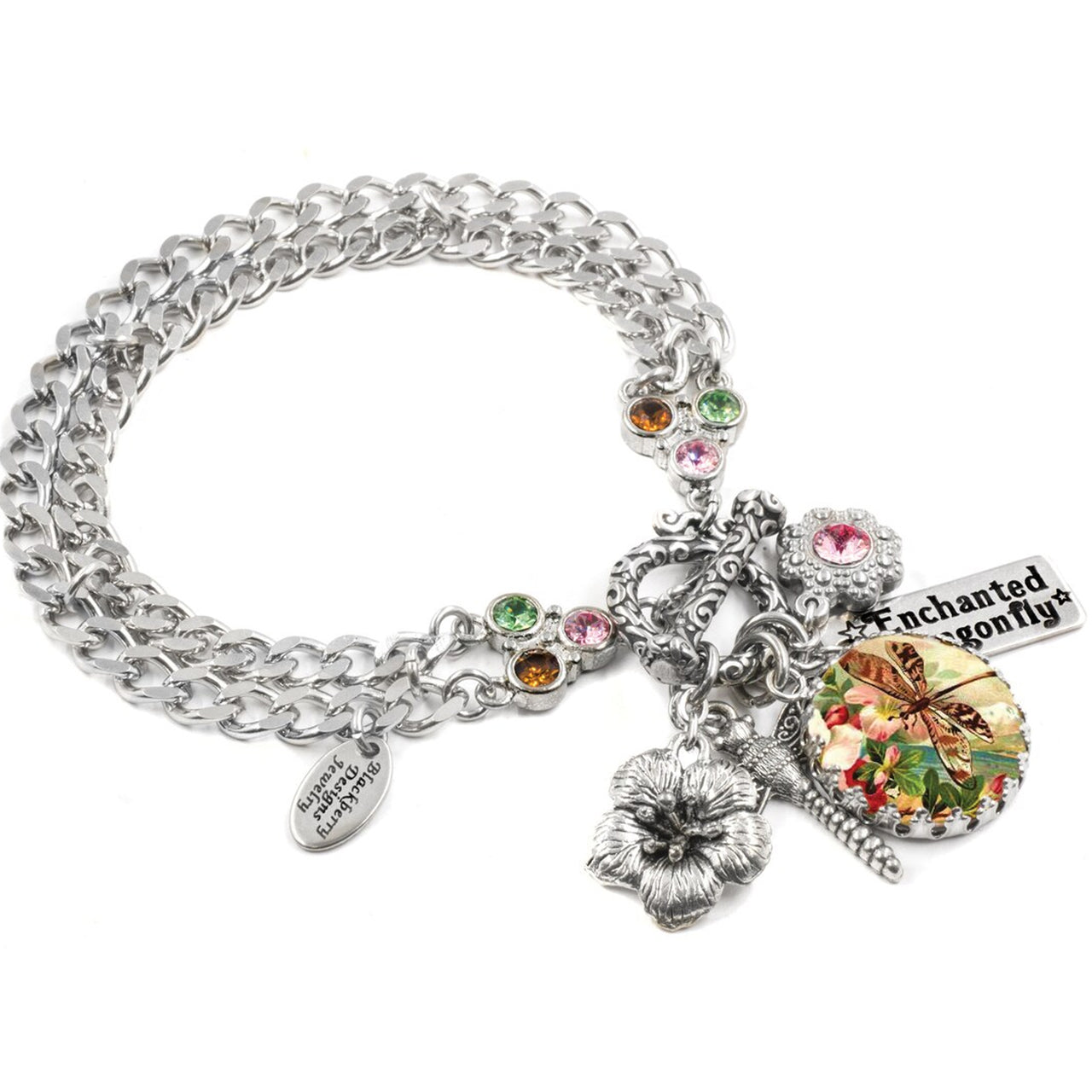 A silver-toned charm bracelet with various charms, including a flower, a butterfly, and a dragonfly, as well as a charm that says "Enchanted Dragonfly".