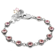 A bracelet with a silver-toned metal design and a charm featuring pink gemstones.
