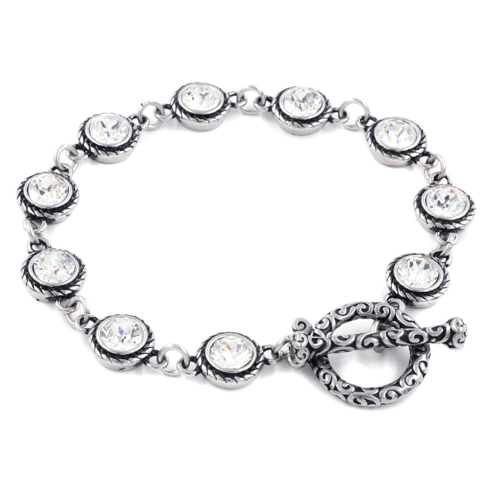 A silver bracelet with a clasp and a row of clear rhinestone stones.