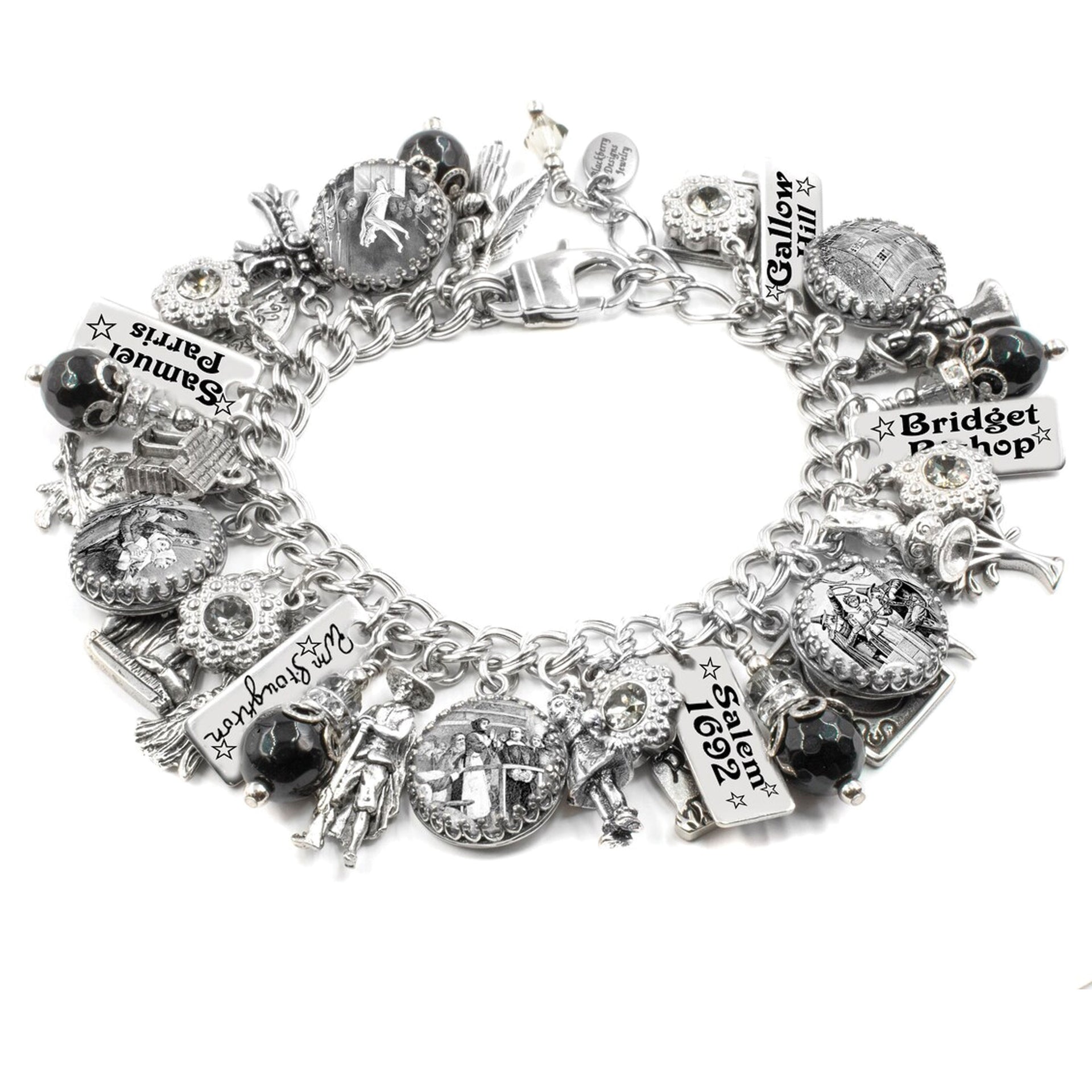 A silver and black charm bracelet with various charms and pendants attached to it.