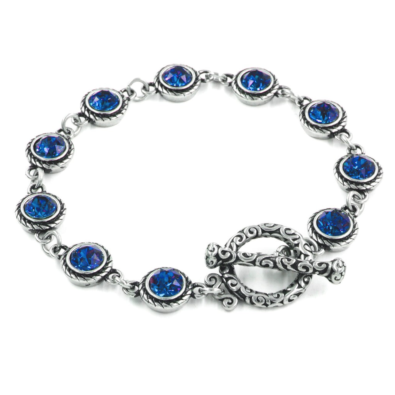 A silver bracelet adorned with blue gemstones, featuring a decorative clasp and a clasp-like element.