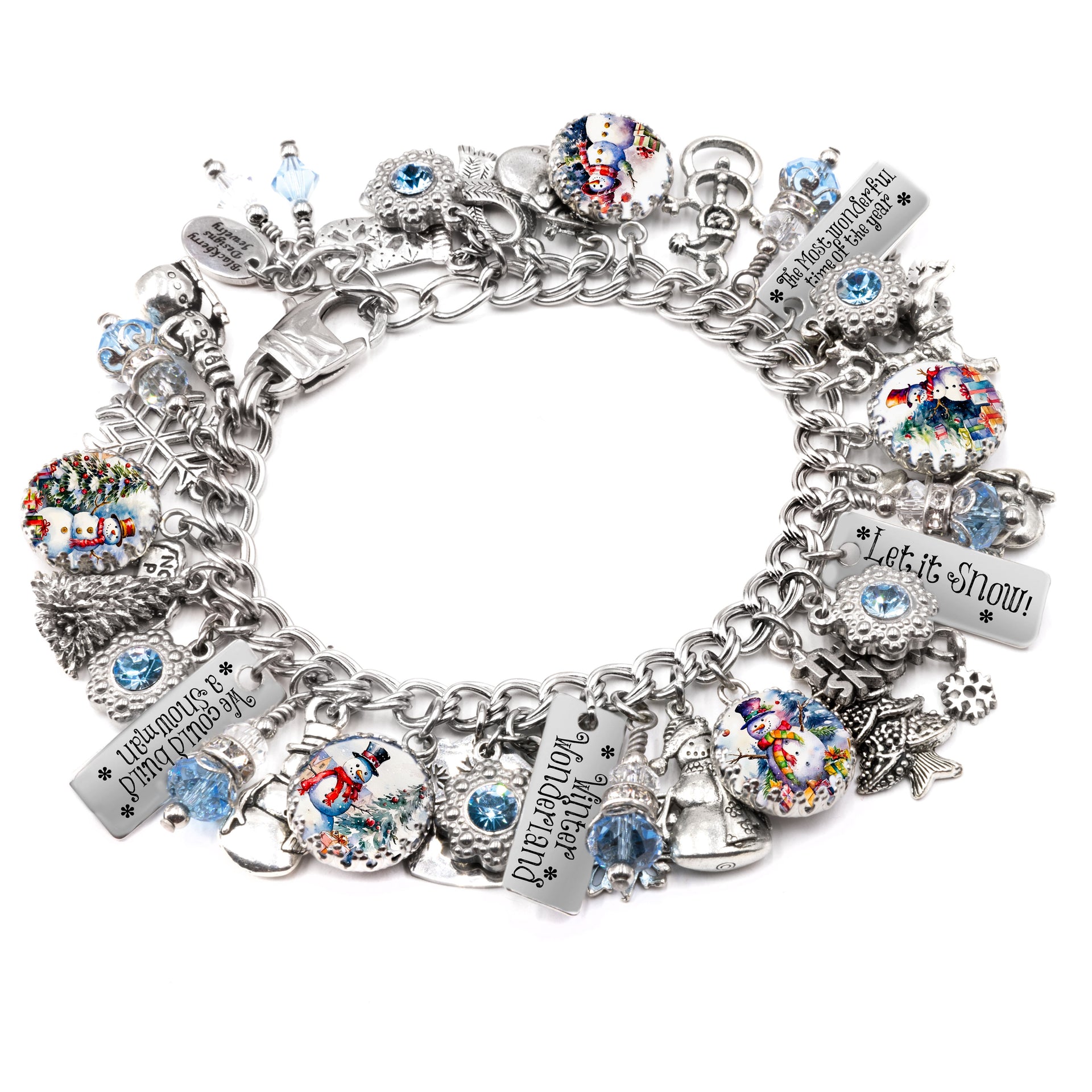 A silver-colored charm bracelet adorned with various charms, including snowmen, bells, and other festive ornaments. The bracelet is decorated with small blue and silver beads, and the charms are arranged in a circular pattern.