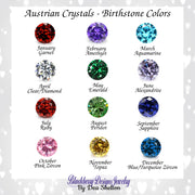 a collection of twelve gemstone diamonds, each representing a different month of the year. The diamonds are colored in various hues, including red, blue, green, purple, and yellow. The text above the image reads "Austrian Crystals - Birthstone Colors", and the text below the image says "Blackberry Design Jewelry By Dea Shelton".