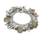 A silver and gold charm bracelet with various charms and charms attached to it.