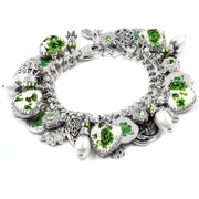 A silver and green charm bracelet adorned with various charms, including hearts, leaves, and pearls, as well as other decorative elements.
