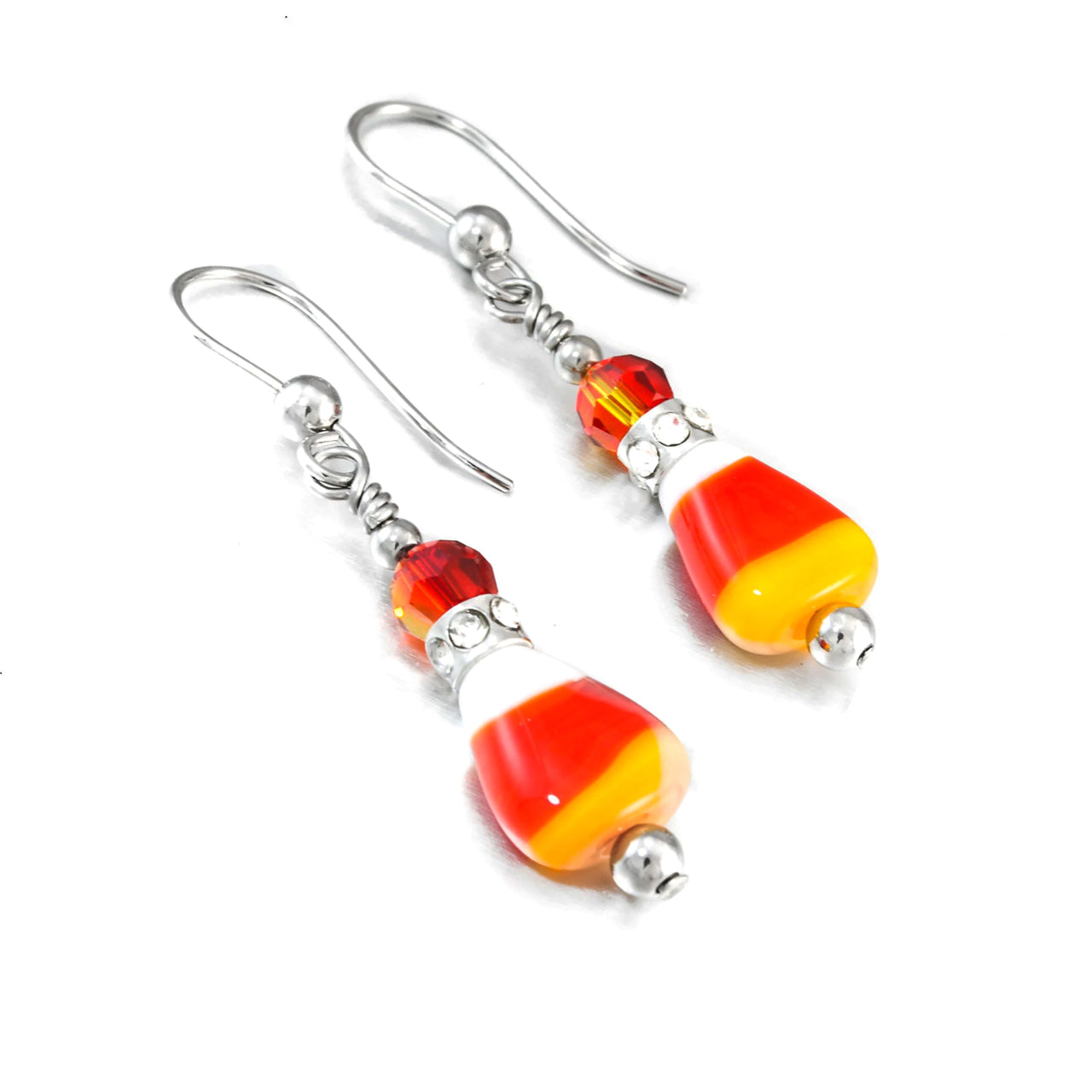 A pair of earrings with candy cane-shaped beads and metal hooks.