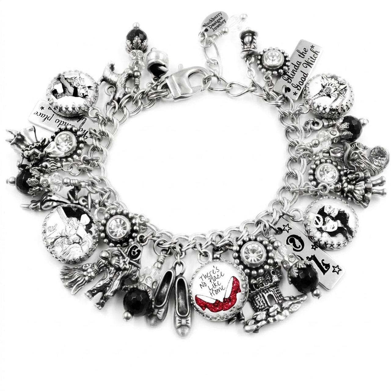 A silver-toned charm bracelet adorned with various charms, including a pair of red shoes, a castle, and other whimsical elements.