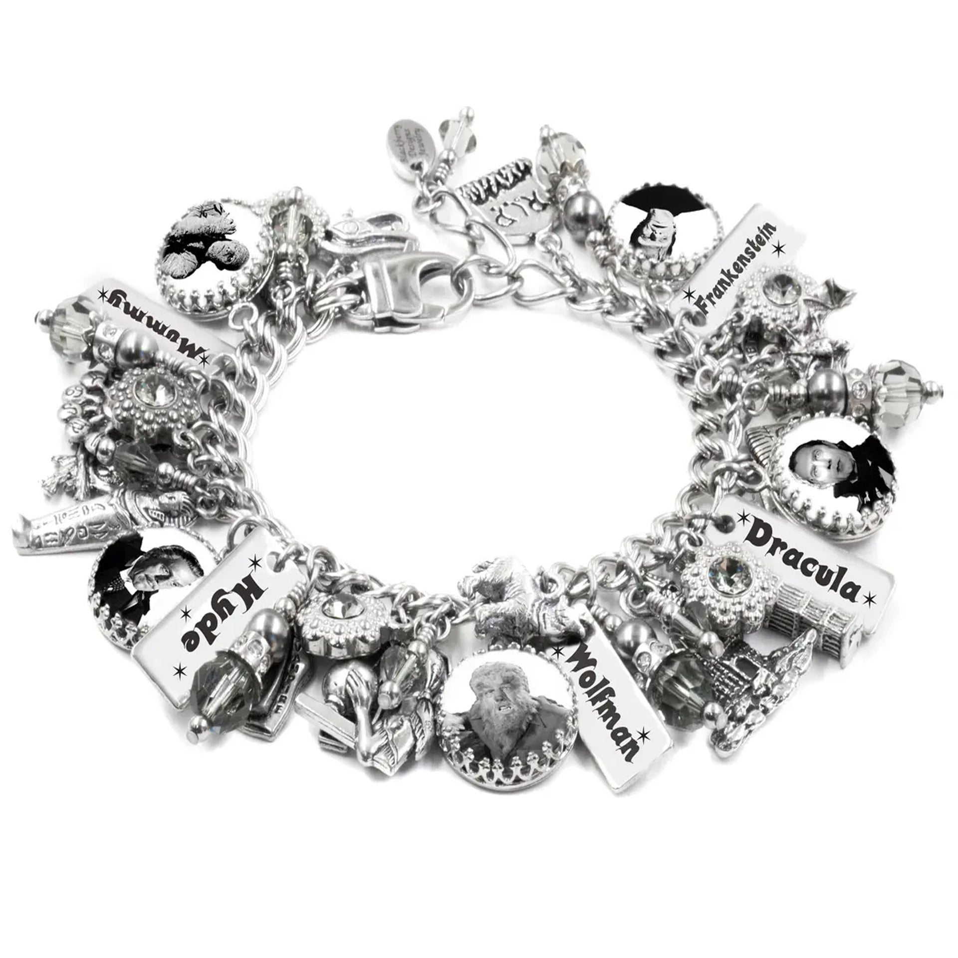A silver bracelet adorned with various charms, including a keychain, a skull, and a castle, as well as charms featuring the names "Frankenstein", "Dracula", and "Wolfman".
