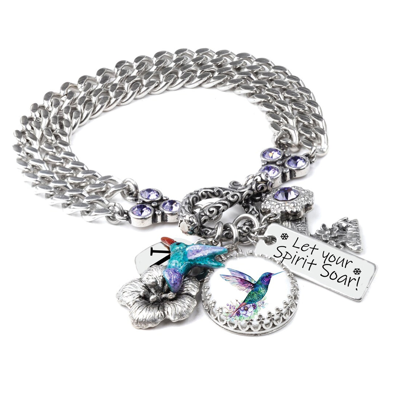 A silver-toned charm bracelet with various charms, including a bird charm, a flower charm, and a small bird charm. The bracelet also has a charm that says "Let your spirit soar!"