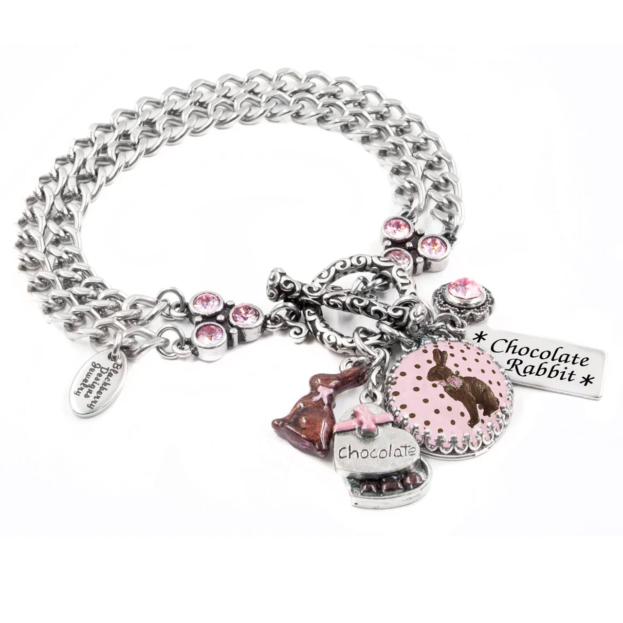 A silver-toned charm bracelet with various charms, including a chocolate rabbit charm, a heart-shaped charm, and a small charm with the word "chocolate".