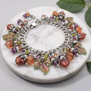 autumn leaves charm bracelet hand painted charms in burgundy purple and green with over 30 charms including carnelian gemstones and crystal pumpkins and amethyst gemstones