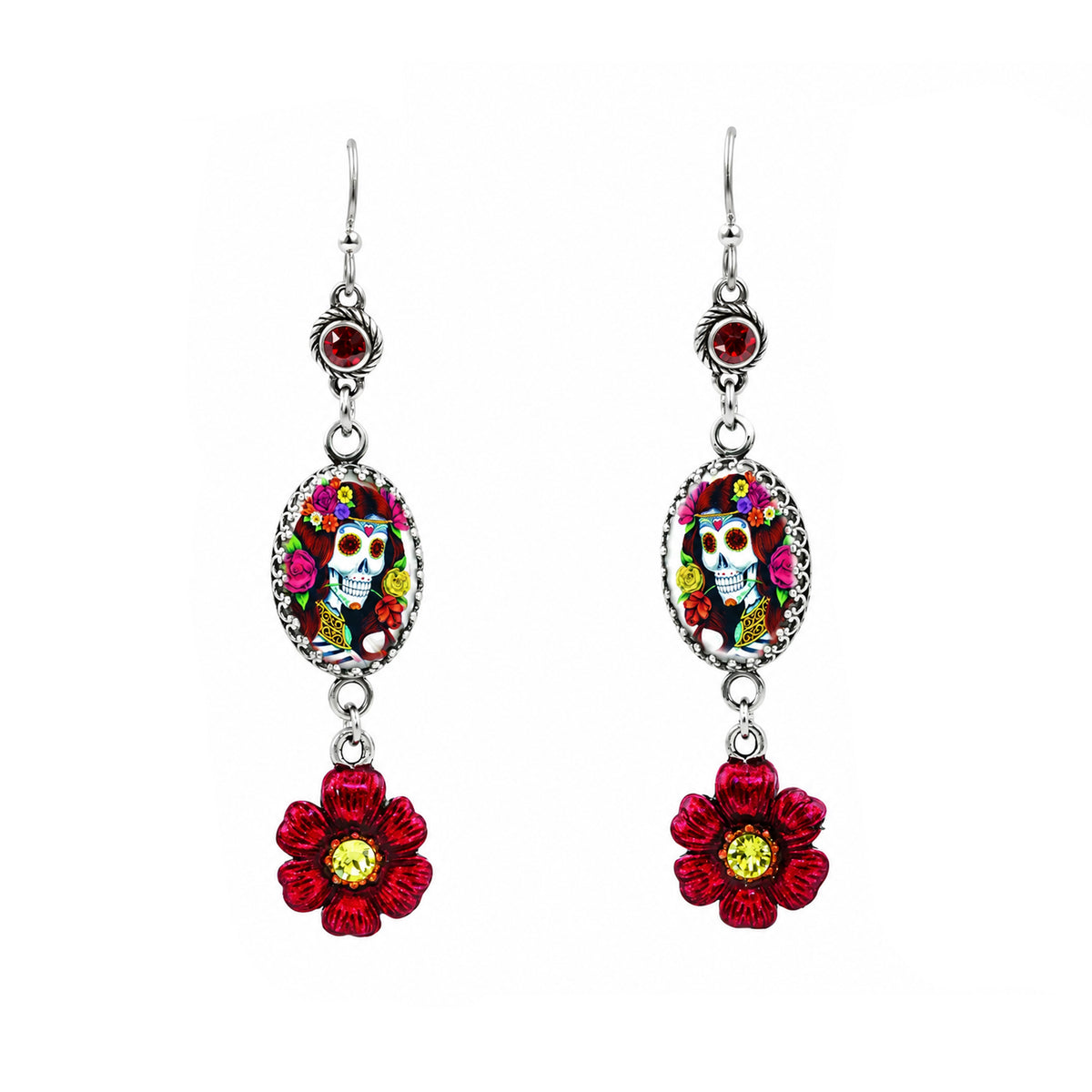 A pair of silver-toned dangle earrings featuring oval Day of the Dead sugar skull medallions and dangling red flower charms with yellow centers, shown on a plain white background.