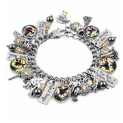 A silver charm bracelet featuring various gothic and fantasy-themed charms, including a broom, skull, dagger, and text plaques, displayed on a clean white background.