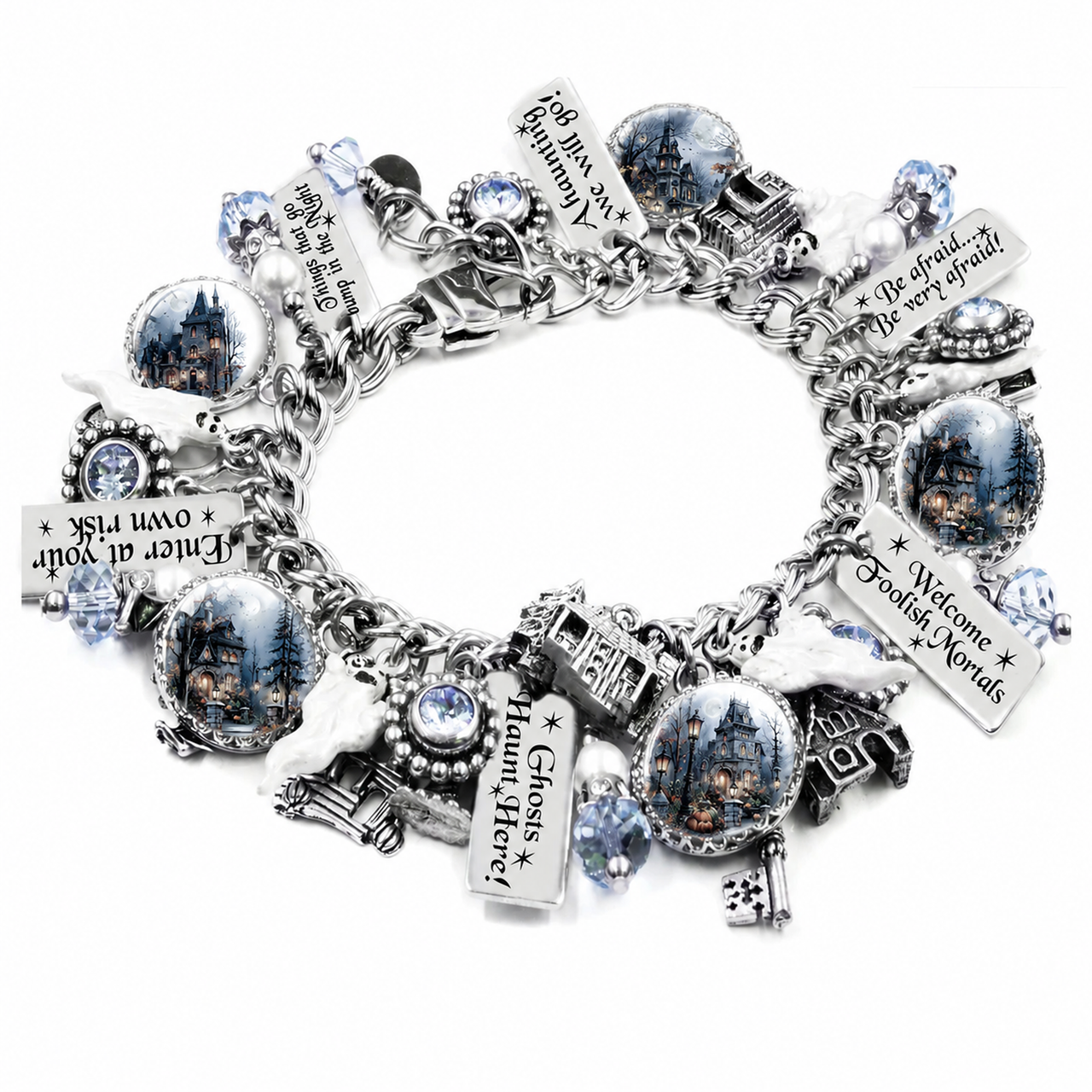 A silver charm bracelet featuring various gothic-themed charms, including haunted house medallions, a ghost house, a key, a bird, and text plaques with phrases like 'Welcome to Ghost Haven' and 'Enter at your own risk', displayed on a clean white background.
