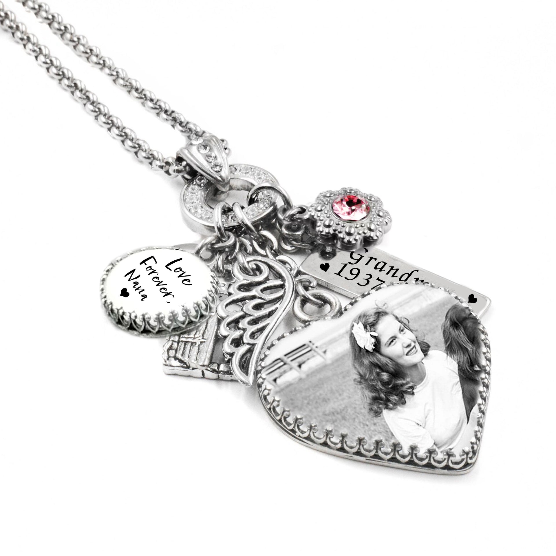 Heart photo memorial necklace with black-and-white picture, angel wing charm, garden gate charm, pink birthstone, engraved bar and round handwriting charm in silver.