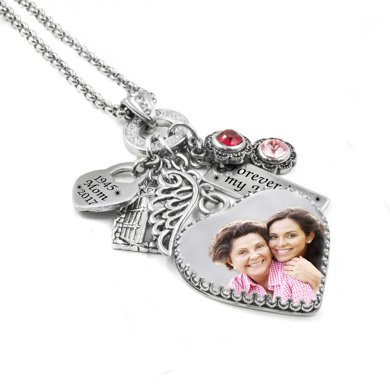 Silver memorial photo necklace with a heart-shaped charm featuring a smiling mother and daughter, angel wing charm, engraved date tag, and pink and red crystal birthstones.
