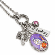 Silver-tone Halloween-themed charm necklace with a 'Mummy' engraved tag, a mummy head charm, a tombstone charm, and an oval pendant featuring a purple mummy wrap background with a jack-o'-lantern and a small giraffe.
