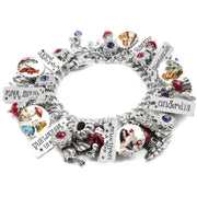 Handcrafted silver charm bracelet inspired by classic fairy tales, featuring charms for Cinderella, Snow White, Red Riding Hood, Sleeping Beauty, and Rumpelstiltskin. Includes vintage-style storybook artwork under glass cabochons, engraved tags with character names and phrases like ‘Once Upon a Time’ and ‘In Wonderland’. Accented with red, purple, and pink Austrian crystals. Displayed on a white background.