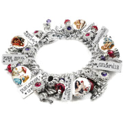 Handcrafted silver charm bracelet inspired by classic fairy tales, featuring charms for Cinderella, Snow White, Red Riding Hood, Sleeping Beauty, and Rumpelstiltskin. Includes vintage-style storybook artwork under glass cabochons, engraved tags with character names and phrases like ‘Once Upon a Time’ and ‘In Wonderland’. Accented with red, purple, and pink Austrian crystals. Displayed on a white background.