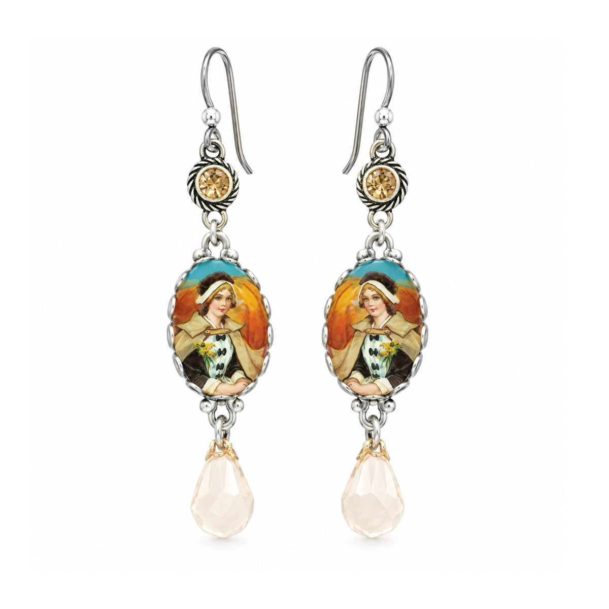 A pair of silver drop earrings featuring oval enamel medallions with a colorful illustration of a woman, accented with a small round gold bead and a dangling faceted pale pink teardrop crystal.
