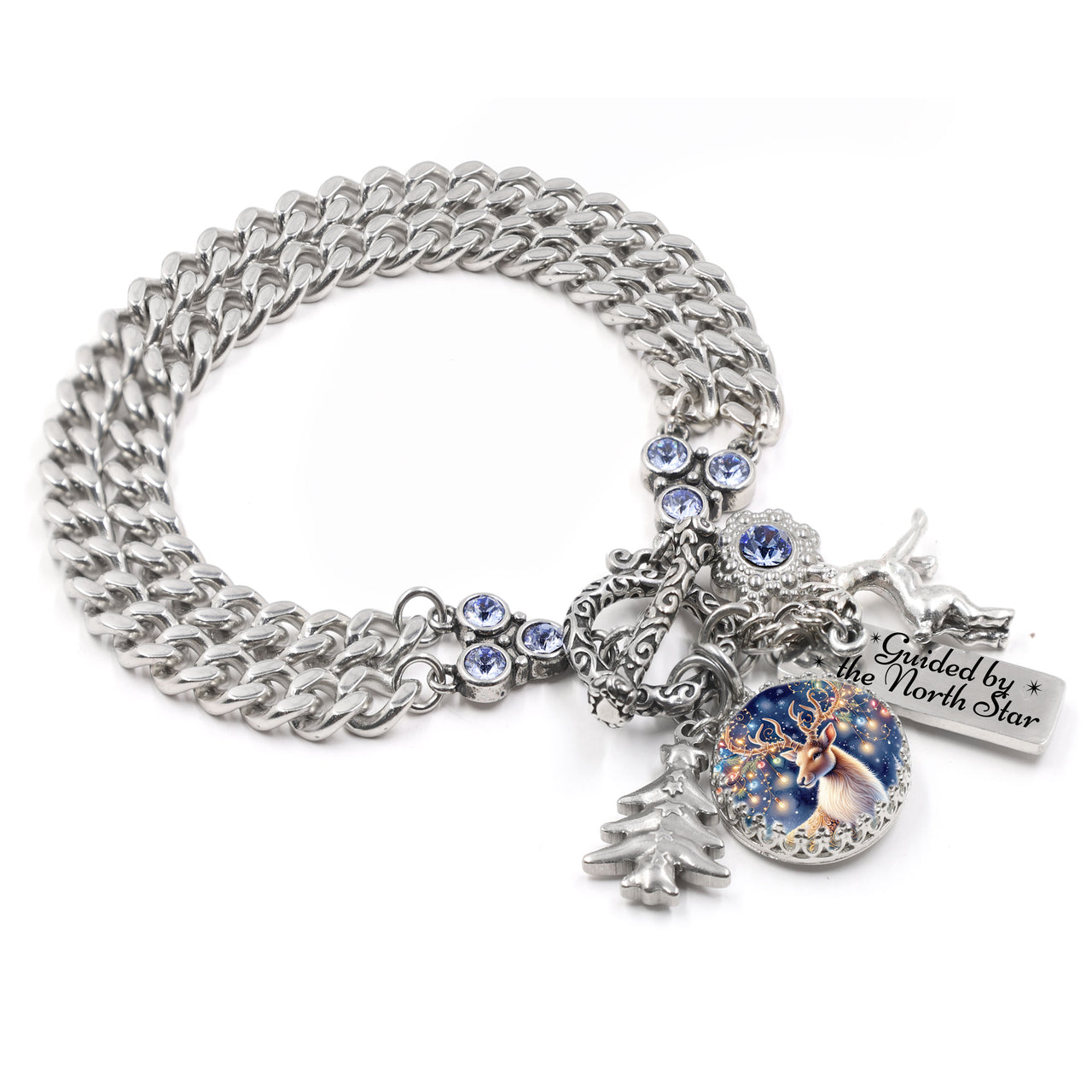 Silver reindeer charm bracelet with sleigh, pine tree, and “Guided by the North Star” tag, blue crystal accent, on tarnish-free stainless chain.