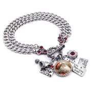 Silver triple-chain Santa charm bracelet with red crystals, vintage Santa cabochon, Jingle Bells charm, and Santa North Pole letter charms on white background