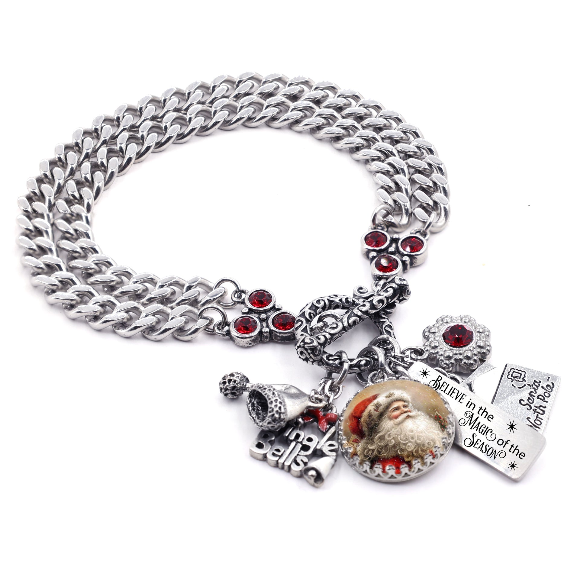 Silver triple-chain Santa charm bracelet with red crystals, vintage Santa cabochon, Jingle Bells charm, and Santa North Pole letter charms on white background