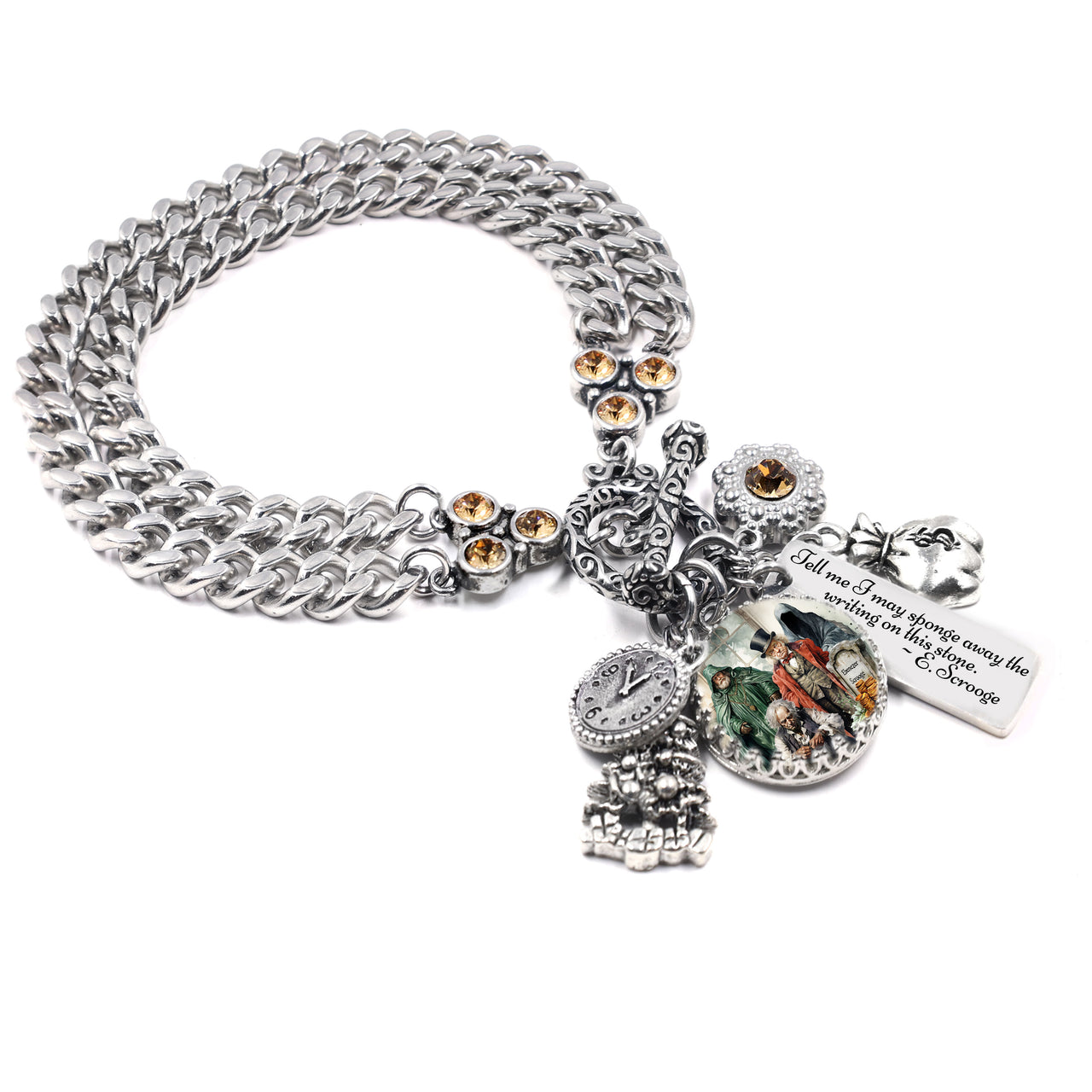 Silver Scrooge charm bracelet with clock, money bag, holly, engraved Dickens quote tag, and topaz crystal accents on stainless chain.