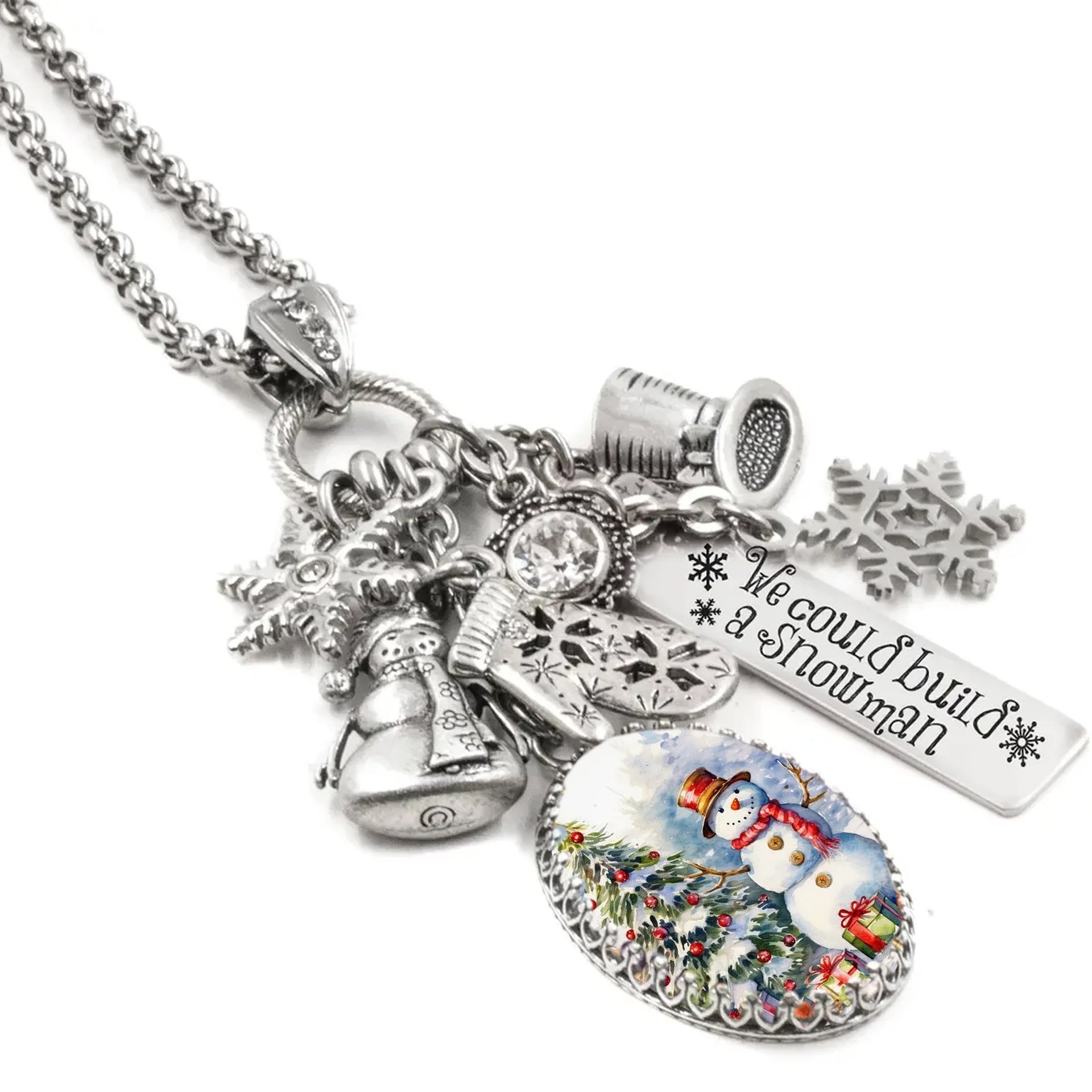Necklace with various charms including a snowman, snowflake, and bell on a white background
