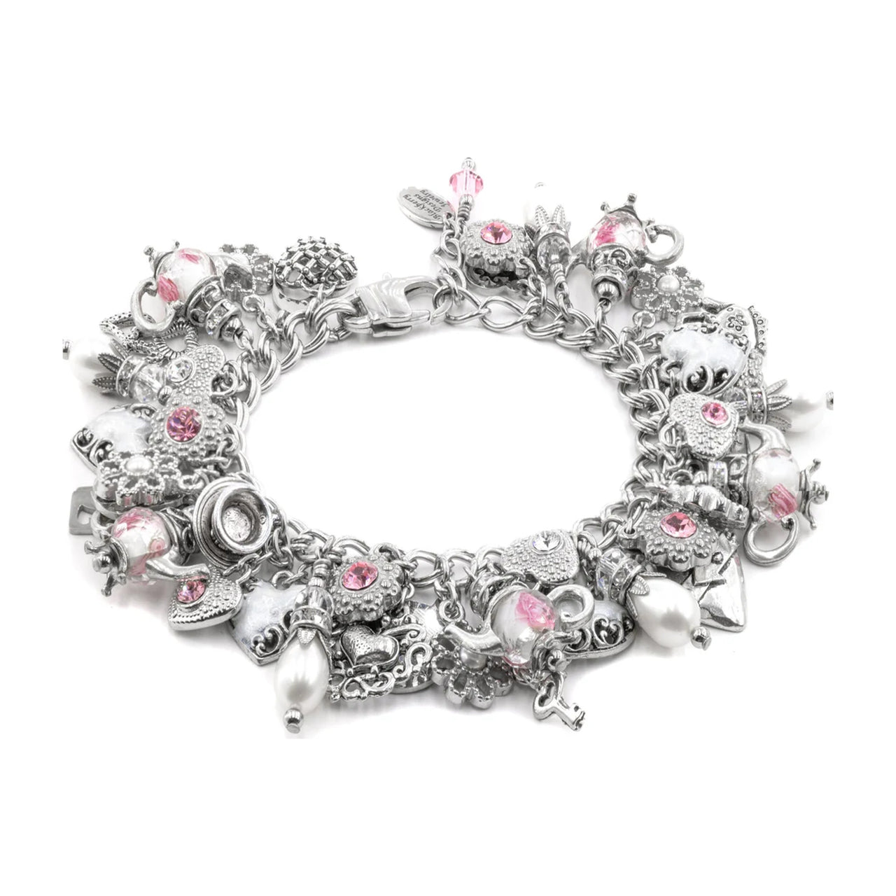 A silver-toned charm bracelet featuring various whimsical charms, including a teapot, skull, crescent moon, and pink gemstone accents, displayed on a clean white background.
