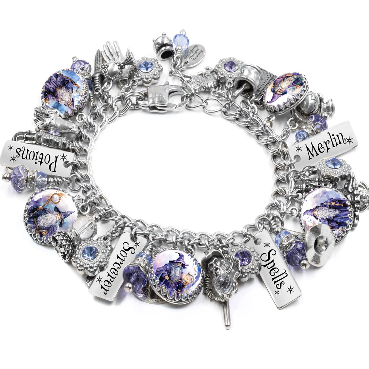 Handcrafted silver charm bracelet with a celestial wizard theme, featuring blue and gold Austrian crystals, engraved tags like “Moonlight Dreams” and “Wishing on Stars,” and fantasy charms including a wizard hat, telescope, shooting star, and spellbook. Displayed on a white background.