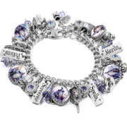 Handcrafted silver charm bracelet with a celestial wizard theme, featuring blue and gold Austrian crystals, engraved tags like “Moonlight Dreams” and “Wishing on Stars,” and fantasy charms including a wizard hat, telescope, shooting star, and spellbook. Displayed on a white background.