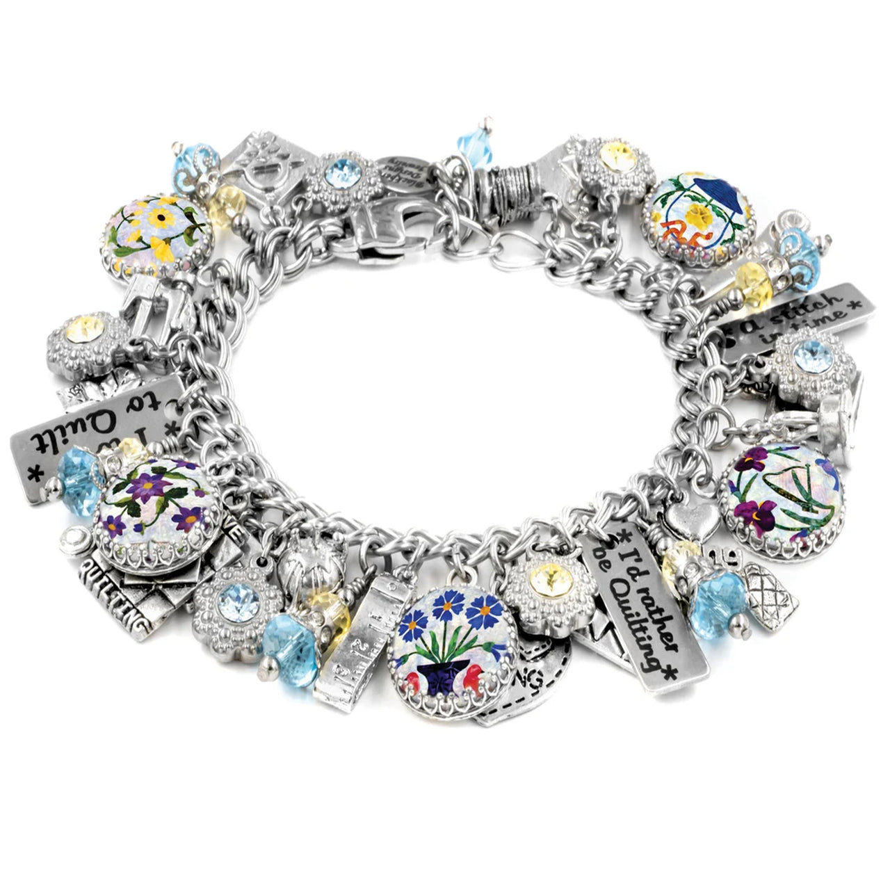 A silver-toned charm bracelet adorned with various charms, including flowers, gemstones, and other decorative elements.