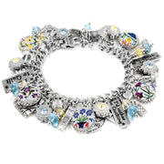 A silver-toned charm bracelet adorned with various charms, including flowers, gemstones, and other decorative elements.