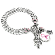 A silver-toned charm bracelet with various charms, including a key, a ribbon, and a pink ribbon symbol, as well as a charm that says "Dove".
